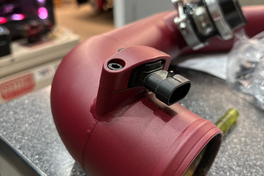 A close up image of a welded MAP sensor bracket 