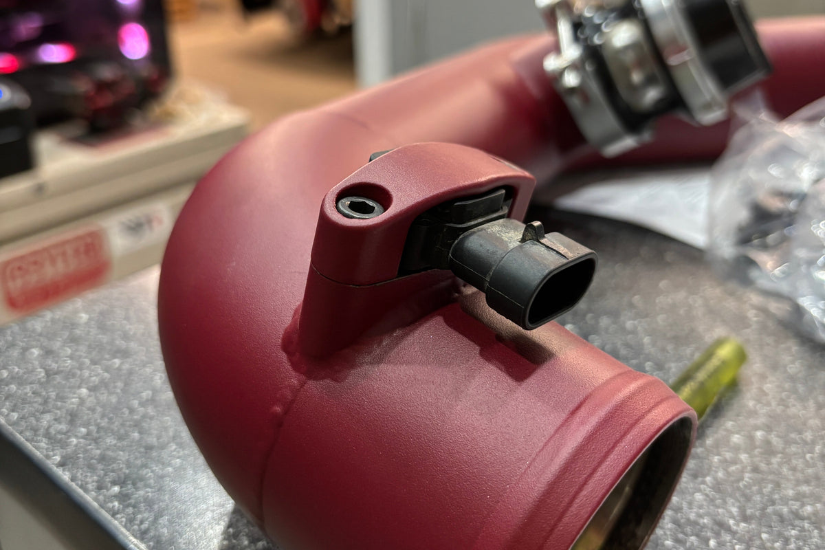 A close up image of a welded MAP sensor bracket 